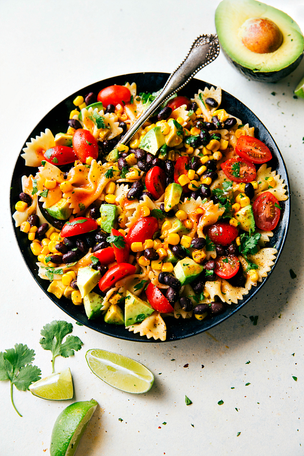 a-delicious-and-super-simple-tex-mex-pasta-salad-with-corn-black-beans-cherry-tomatoes-and-avocados-an-easy-catalina-dressing-tops-this-salad